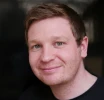 Headshot of Jaymeh with slightly smiling face