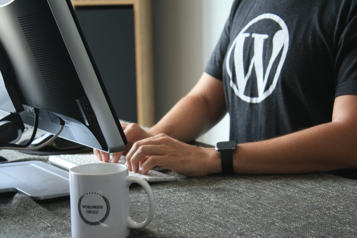 wordpress developer at keyboard in black shirt