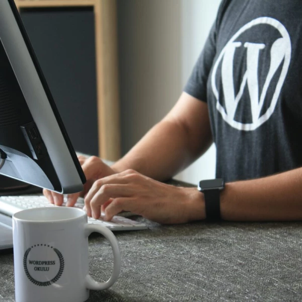 wordpress developer at keyboard in black shirt